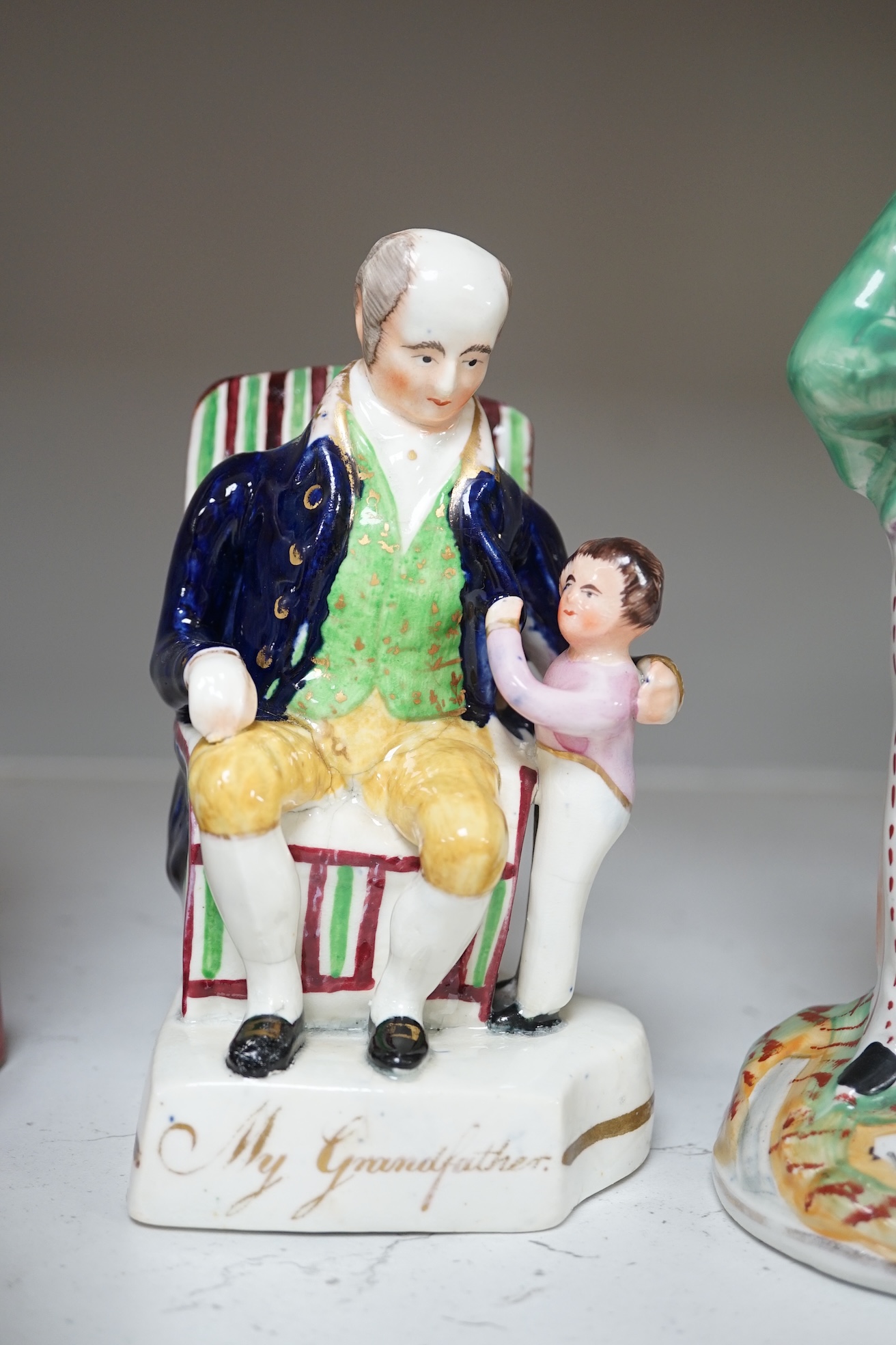 Six mid 19th century Staffordshire figures or groups: a pair titled ‘my grandmother and my grandfather’, a double sided water/gin figure, a pair of figural spill vases and a pearlware group titled ‘Departure’, the talles